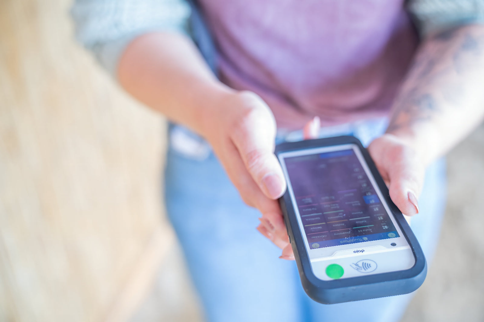 Person holding a smartphone with a screen displaying a graph or chart.
